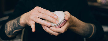 Wicked Beard Company man with arms held out holding a tin of beard balm